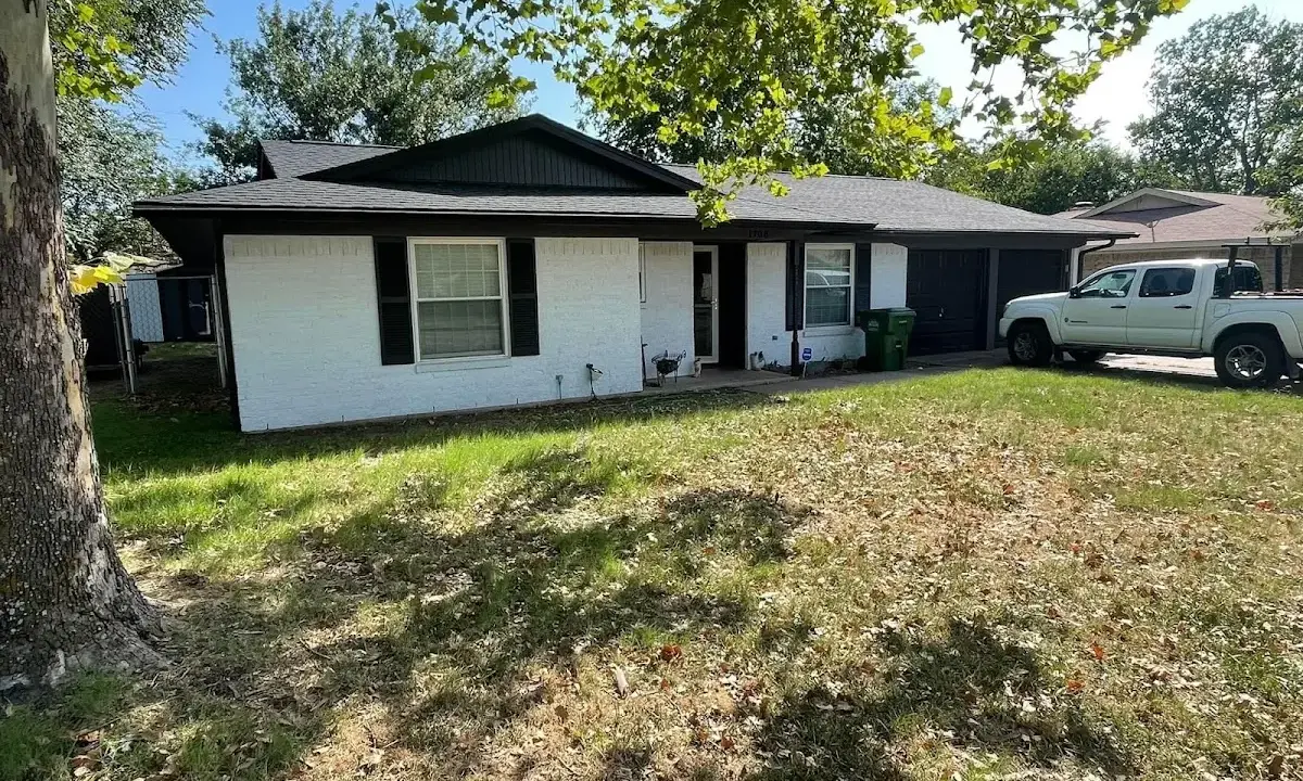 Professional roofing crew working on a residential roof in Lindenhurst